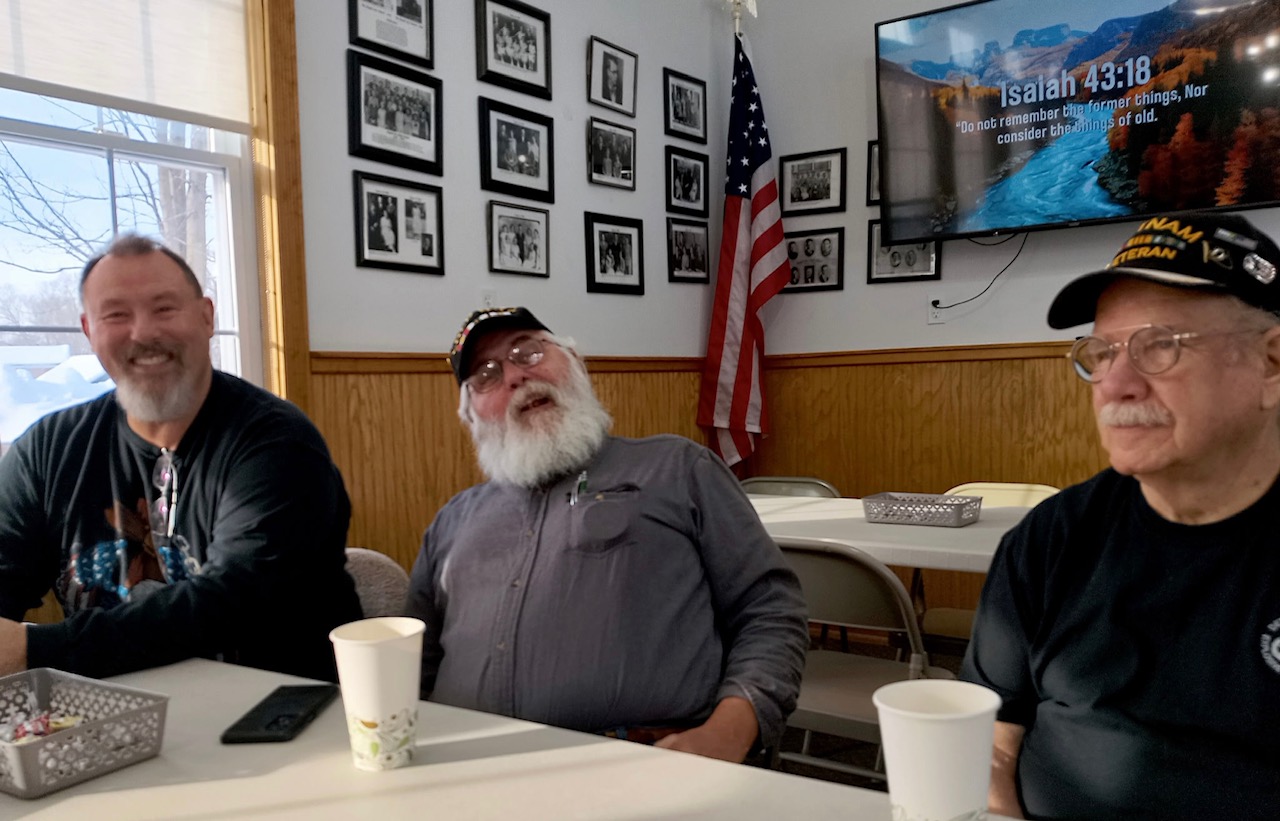 Tony, Jim, and Dave participating in church fellowship.